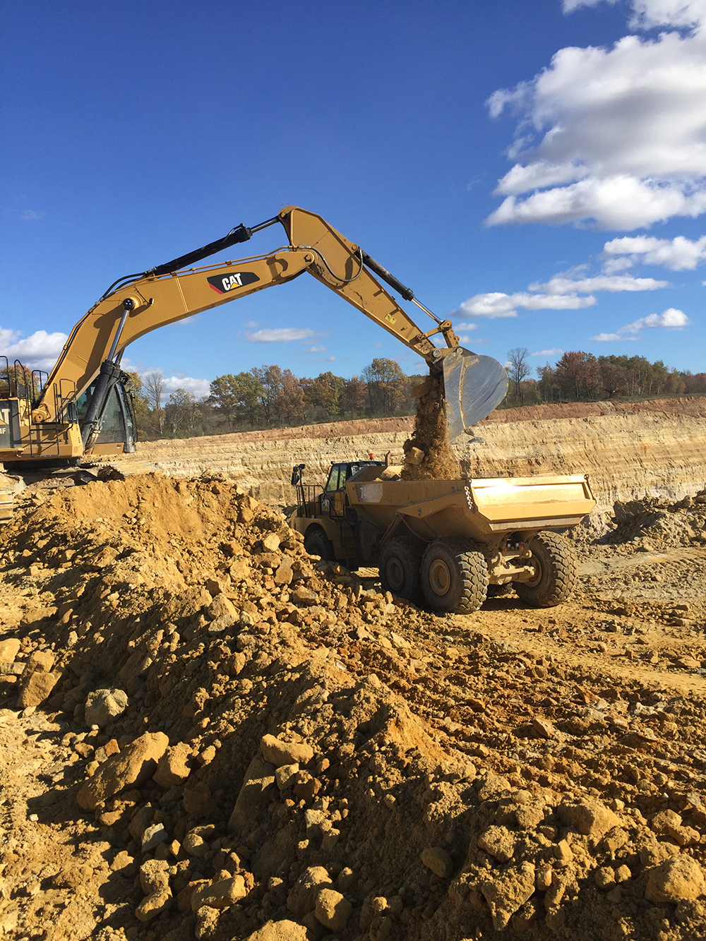 Excavator loading material into a haul truck