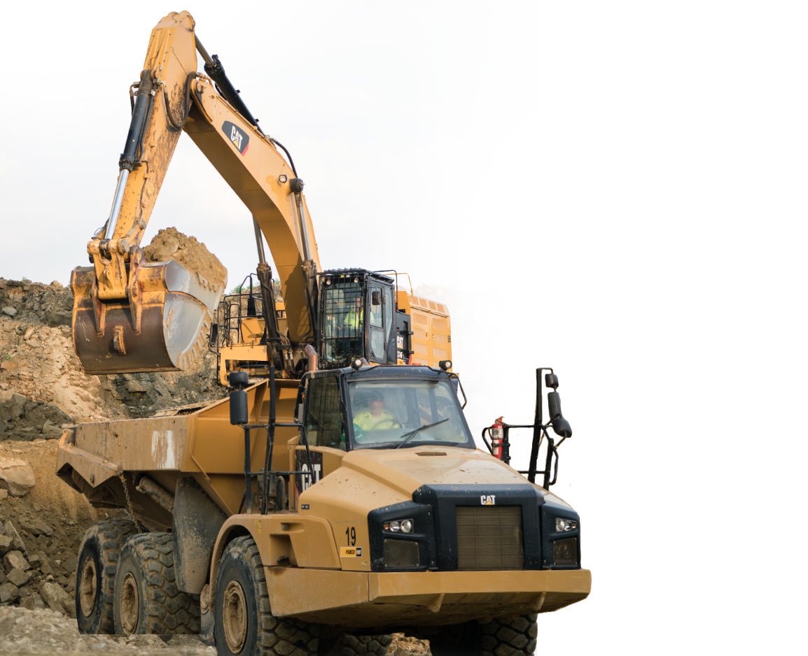 Excavator loading an articulated haul truck at an earthmoving operation